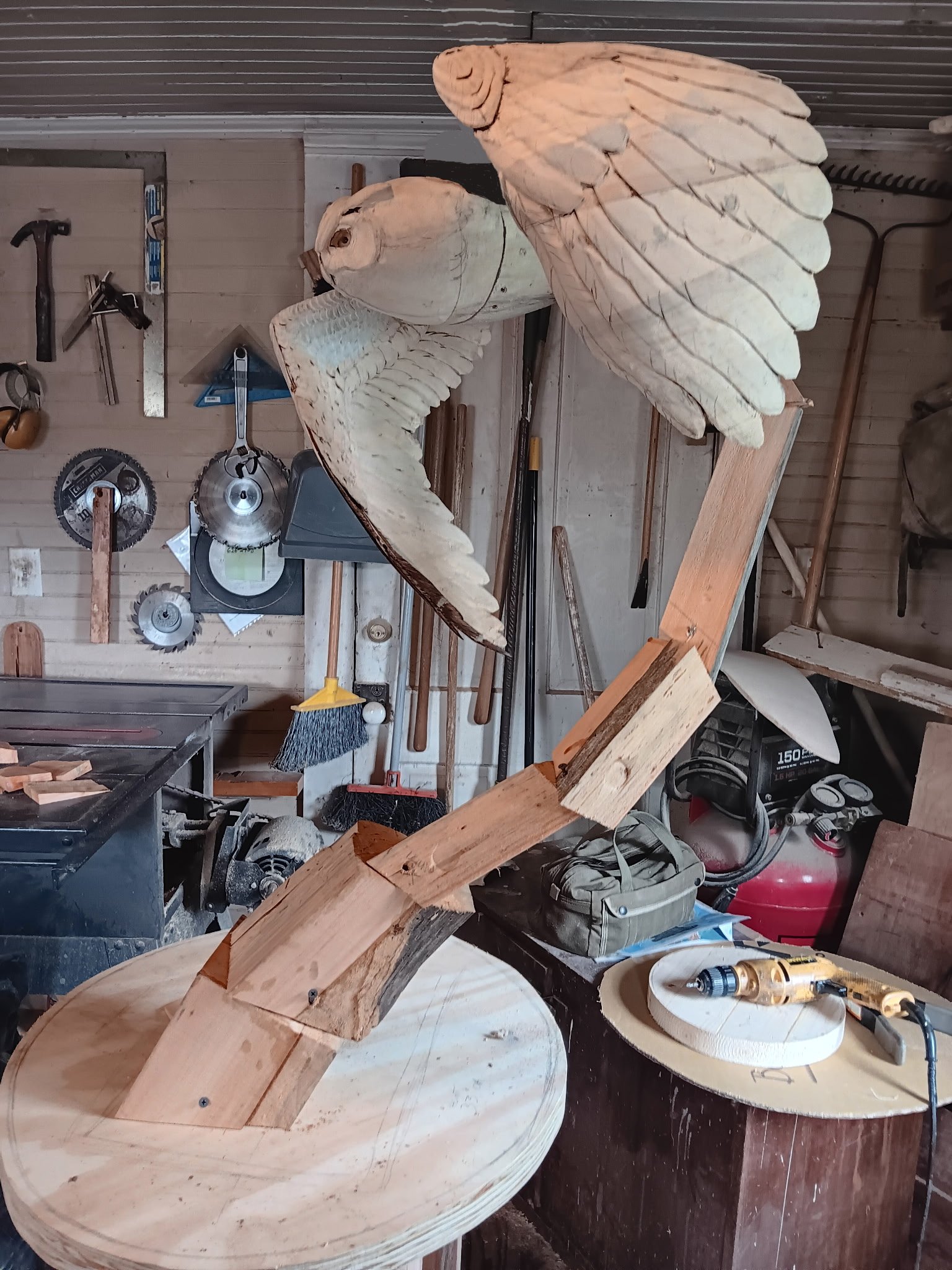Owl sculpture in progress, front view in workshop